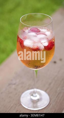 Fresh summer cocktail with strawberry and ice cubes. Glass of strawberry soda drink on dark background. Fresh strawberry cocktail Stock Photo
