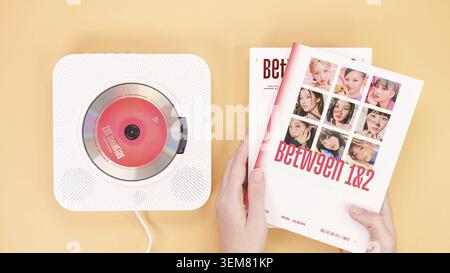 Twice Between 1 and 2 mini Album Box set on yellow. Red music disc in white cd player. South Korean girl group Twice. Space for text. Gatineau, QC Can Stock Photo