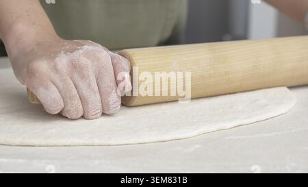 Hands Shaping the dough into ball by hand. chef Preparing the dough for baking pizza bread in the restaurant, baking Stock Photo