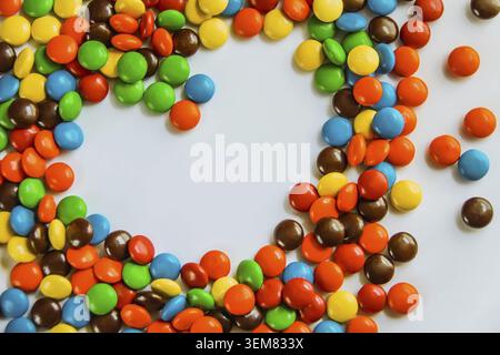Heart made of candy on a white background. the heart of the bright jelly beans. a sweet gift for Valentine's day Stock Photo