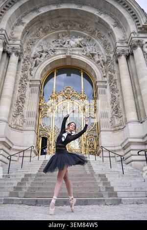 Ballerina performing gracefully near architectural entrance Stock Photo