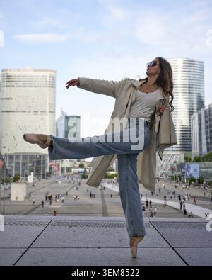 Modern ballerina performing elegant dance pose outdoors Stock Photo