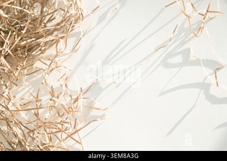 Minimalist stationery mockup with blank kraft card on shredded paper filler background. Stock Photo