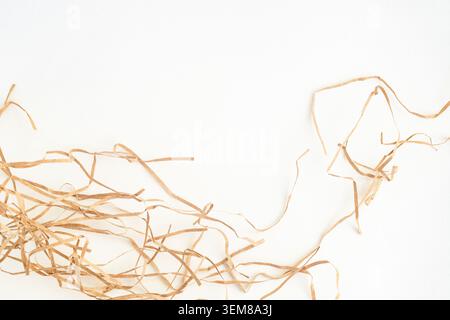Minimalist stationery mockup with blank kraft card on shredded paper filler background. Stock Photo