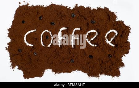 Coffee Word Written in Ground Coffee Powder with Roasted Beans on White Background Stock Photo