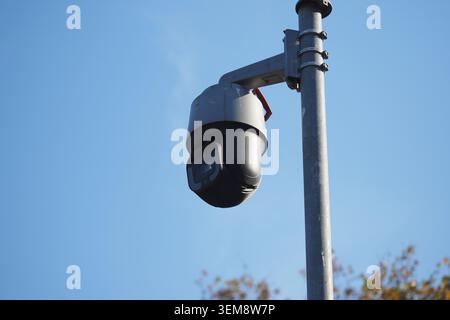 Security camera mounted on pole during daylight hours Stock Photo