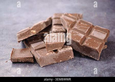 Chocolate pieces on a dark surface ready for use Stock Photo