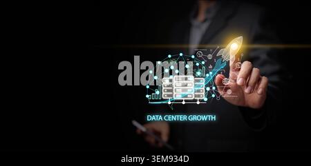Businessman pointing at digital network overlay with data center server, infrastructure expansion, and rocket launch. Rapid growth in cloud computing, Stock Photo