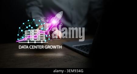 IT specialist or developer working on laptop, pointing at digital network overlay of data center servers, rocket launch. Cloud optimization, AI backen Stock Photo