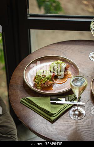 Eggs benedict brunch served with sparkling wine Stock Photo