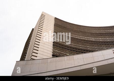 Modern brutalist building featuring curved concrete facade and strong lines Stock Photo