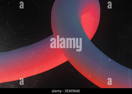 Abstract 3D tubular shape with red and blue gradient on dark background featuring vintage film grain and scratches Stock Photo