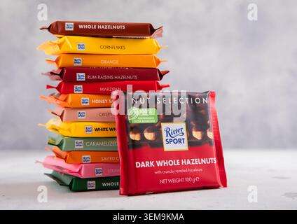 LONDON, UK - MARCH 11, 2026: Ritter Sport chocolate bar with whole hazelnuts with stack of assorted bars on light table Stock Photo