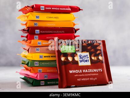 LONDON, UK - MARCH 11, 2026: Ritter Sport chocolate bar with whole hazelnuts with stack of assorted bars on light table. Stock Photo