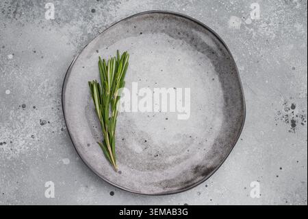 Minimal gray plate on concrete background. Clean flat lay mockup with copy space and texture Stock Photo