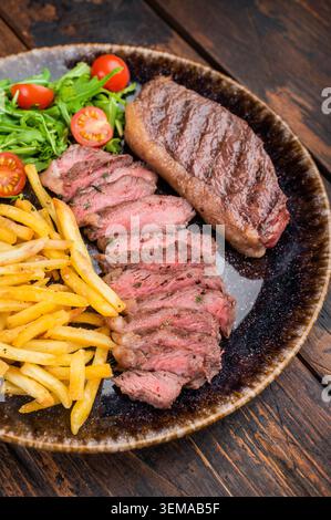 On Top Table Grilled picanha steak sliced and served on a rustic gray plate with ...