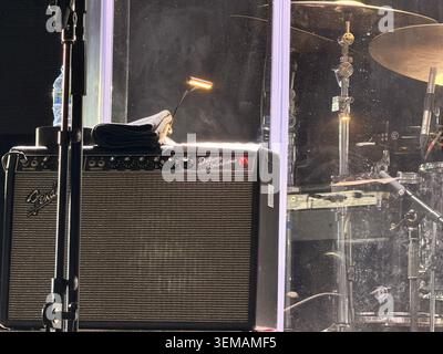 Close view of Fender amp and drum kit on dimly lit stage Stock Photo