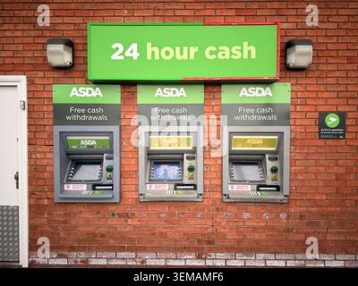 Three free withdrawal ATMs in secure cardholder area with CCTV security signage. Stock Photo
