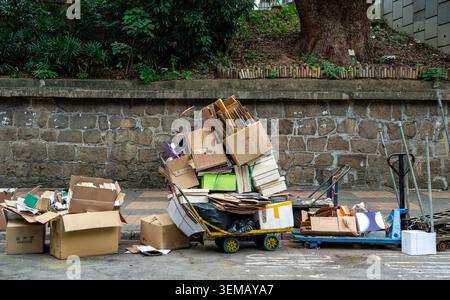 Large Stack of Cardboard Boxes Piled on a Hand Trolley for Recycling on an Urban Street Stock Photo