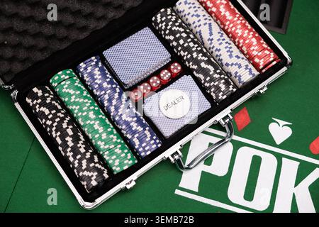 Playing cards and chips in a case on table Stock Photo