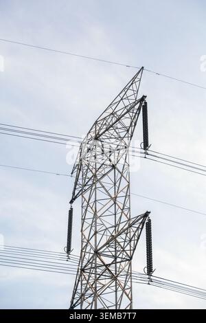 High Voltage Power Line Tower on sky background Stock Photo