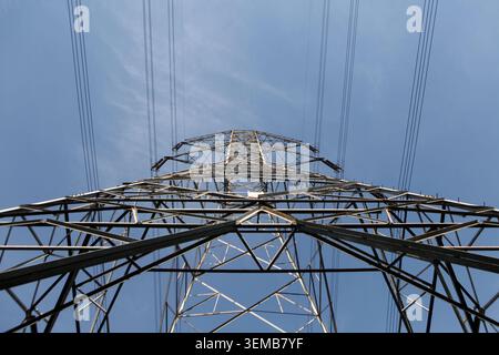 High Voltage Power Line Tower on sky background Stock Photo