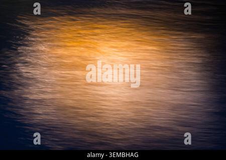 Ethereal golden light streaks on a dark background created with ICM. Abstract motion blur texture conveying energy, innovation, and fluidity. Perfect Stock Photo