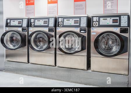 Almaty, Kazakhstan - May 02, 2026: Washing machines in a self-service laundromat. Convenient use. Full cycle Stock Photo