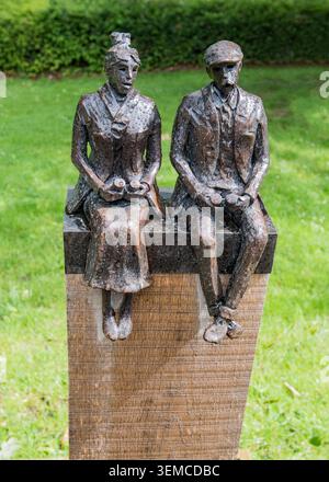 Small figures sitting on a post near the cafe at the Himalayan Garden, Grewelthorpe,near Ripon, North Yorkshire, UK. Stock Photo