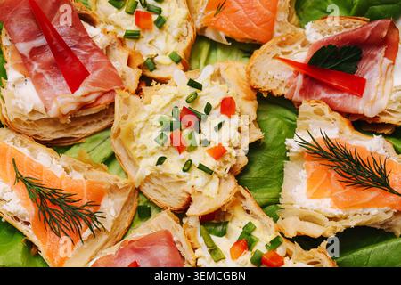 Assorted salmon and egg appetizers on bread slices. Party finger food selection for catering, buffet and festive gatherings. Stock Photo