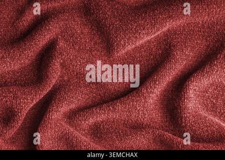 Closeup, macro of red microfiber fabric texture with soft folds and drapery. Plush, fleece textile surface suitable for background, wallpaper and desi Stock Photo