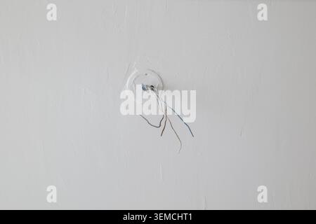 Exposed electrical wires in ceiling Stock Photo