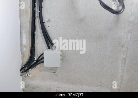 Electrical junction box and wires on concrete ceiling Stock Photo