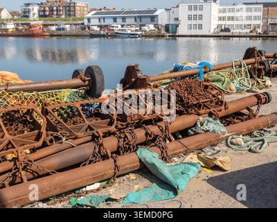 Close up of rusty fishing gear, trawling equipment, chains and booms on the quayside in Shoreham Harbour Stock Photo