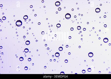 An artistic composition featuring various-sized droplets on a smooth surface. The captivating pattern highlights beauty in minimalism and abstraction, Stock Photo
