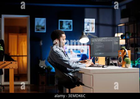 System administrator coding IT script for cloud computing, working on software development with computer language. Technician specialist typing binary code on html terminal window. Stock Photo