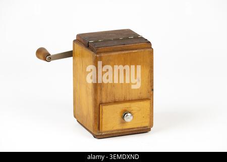 A nostalgic wooden coffee grinder with crank and drawer, old kitchen appliance Stock Photo
