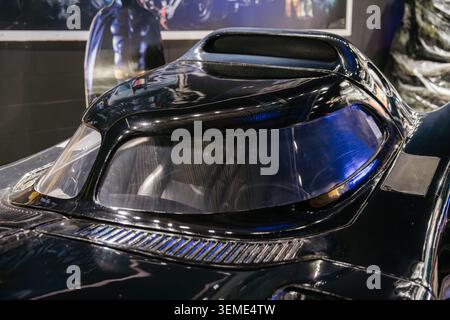 Close-up shot captures sleek, black futuristic car with glossy finish and aerodynamic dome. Interior structure visible through transparent windshield, Stock Photo