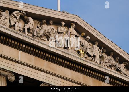 British Museum pediment and sculptural frieze by Robert Smirke, Greek Revival facade, Bloomsbury, London, against a clear winter blue sky. Stock Photo