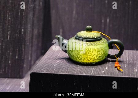 Carved jadeite teapot with floral relief decoration and tassel, Qing dynasty, British Museum Chinese collection, London, January 2025. Stock Photo