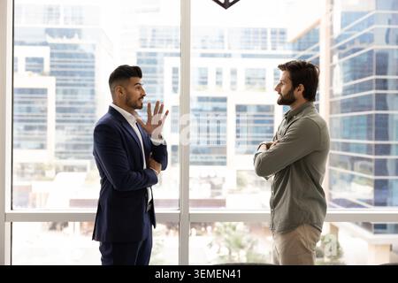 Two businessmen exchanging ideas in modern office Stock Photo