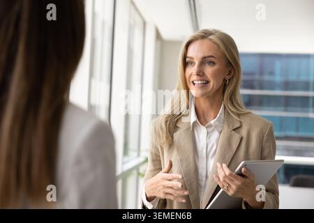 Businesswoman presenting ideas to colleague during meeting in office Stock Photo