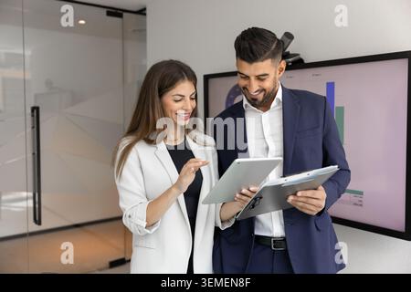 Business team working on digital tablet in office Stock Photo