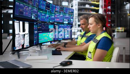 Man And Woman Engineers Discuss Rocket Design Using Desktop Computer Screen. Stock Photo