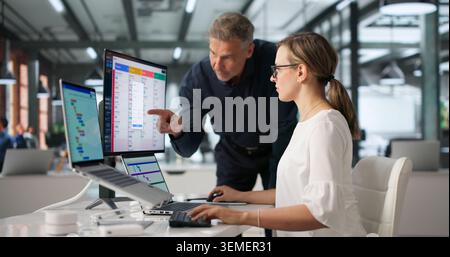 An Agile Manager Guides Team Members Using Scrum Board For Task Planning. Stock Photo