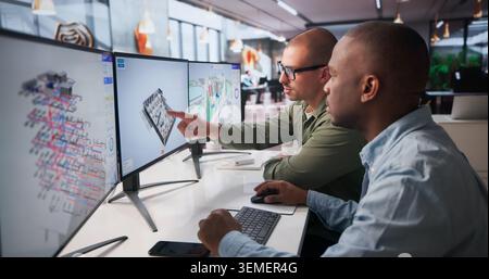 Two Engineers Collaborate On 3D BIM Software For Construction Planning. Stock Photo