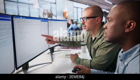 Two Young Software Engineers Work Together Coding Secure Web Applications. Stock Photo