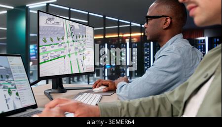 Two Civil Engineers Use 3D Software Analyzing Urban Traffic Flow Carefully. Stock Photo
