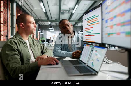 Project Manager And Team Member Review Gantt Chart Schedule Together. Stock Photo