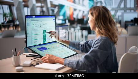 Executive Woman Uses Computer Dashboard To Track Company Goals Progress. Stock Photo